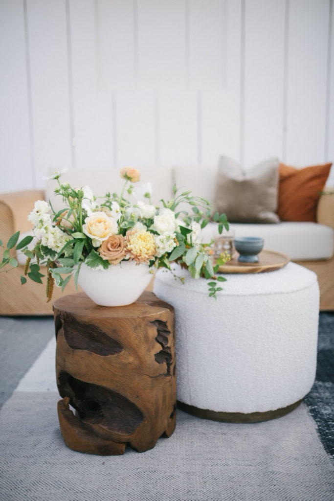 Textured ottoman and driftwood accent table design by Avenue Twelve wedding rentals