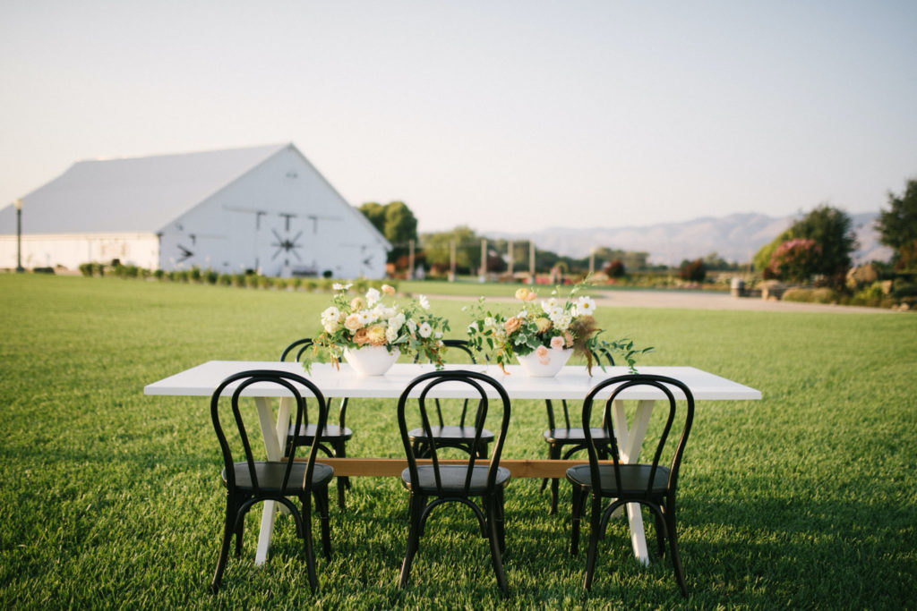 Modern Rustic table design with contrasting chairs and table by wedding rental company Avenue Twelve